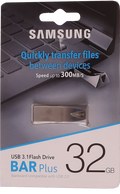 Samsung USB 3.1 flash drive packaging with text on a blurred keyboard background