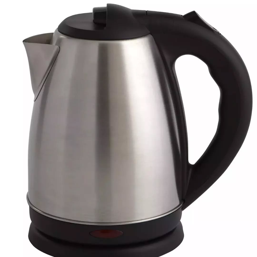 Stainless steel kettle with a cup of tea and cookies on a beige background