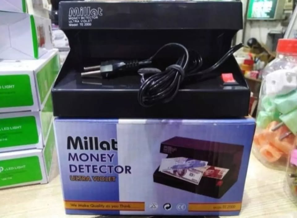 Millat money detector machine in packaging with visible branding and product details.