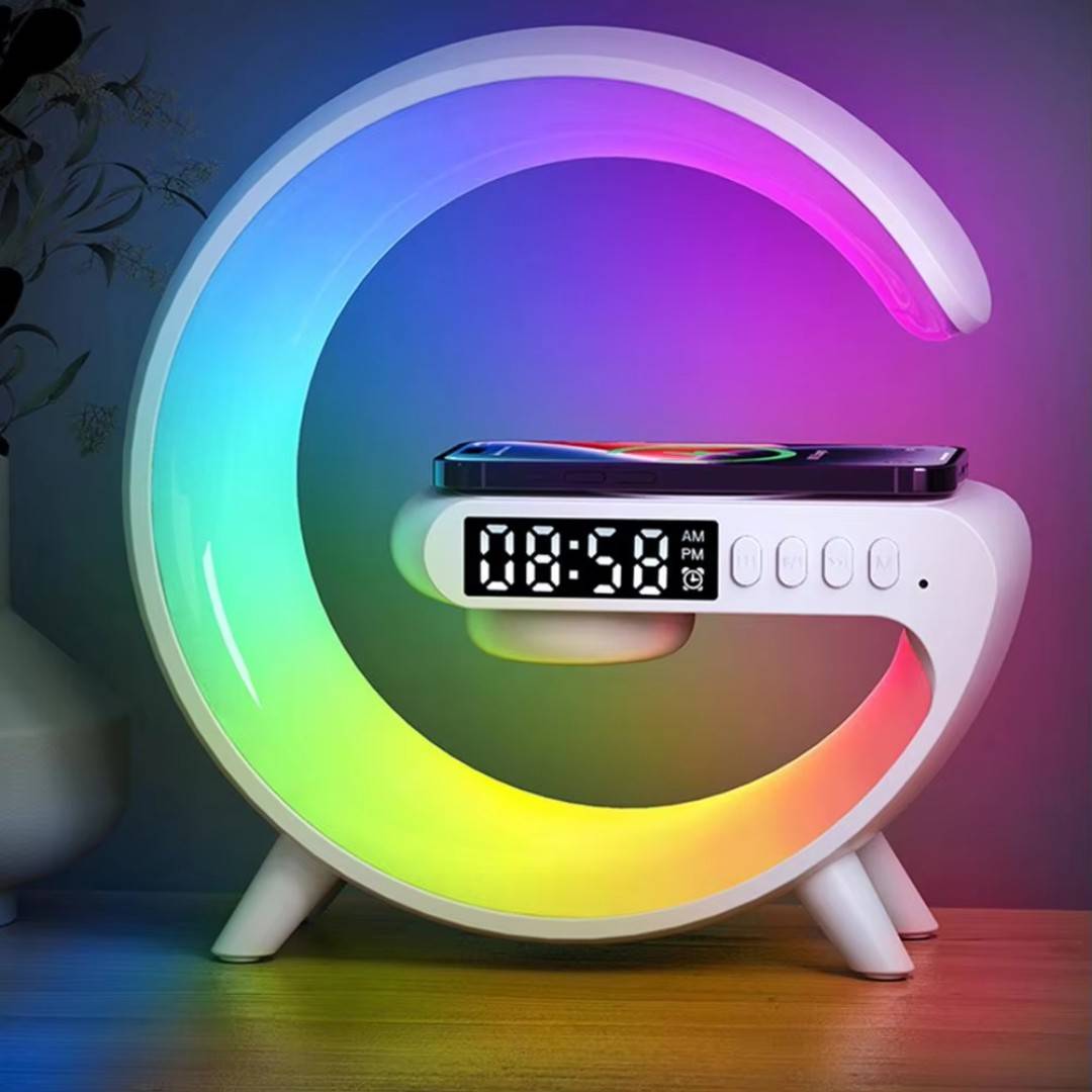 Colorful moon-shaped night light with digital clock on a wooden surface.